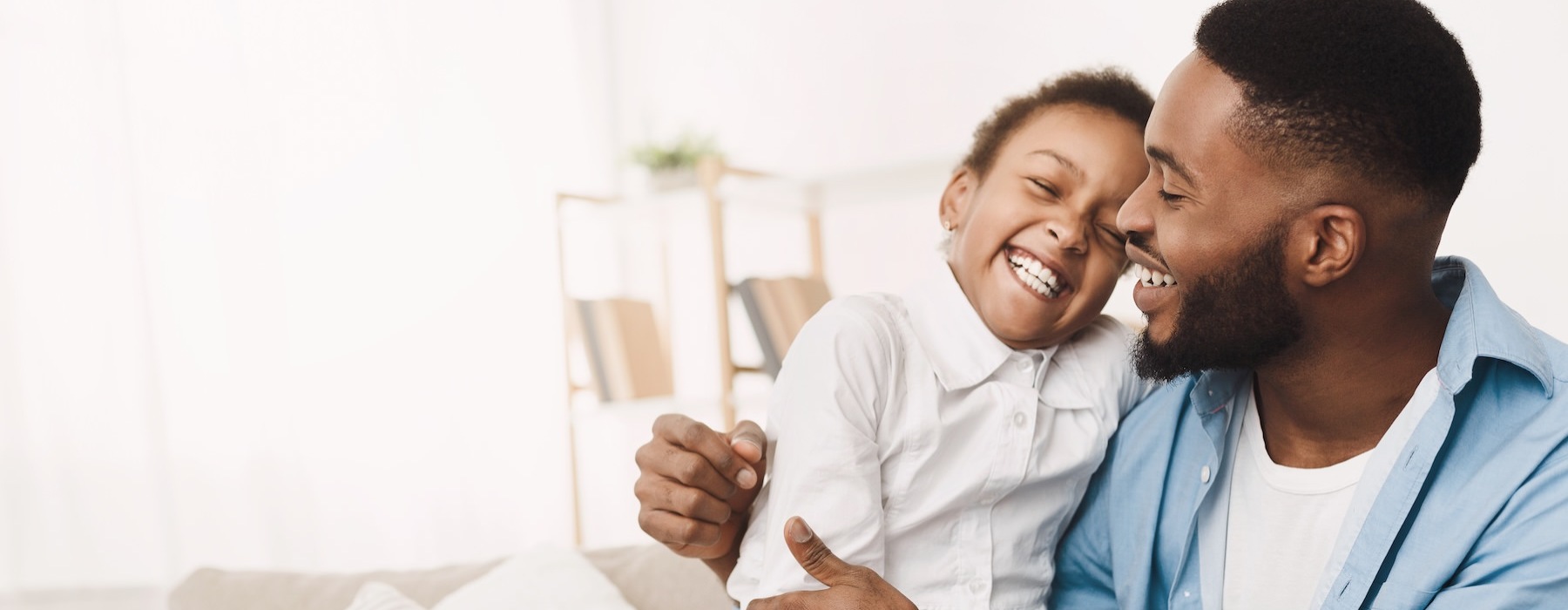 a man holding a child on a couch