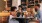 a group of people sitting at a table with cups of coffee