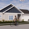 a man riding a bicycle in front of house
