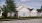 a couple of people standing in front of a house