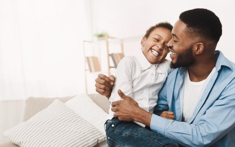 a man and a child laughing