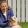 a person kneeling down next to a dog