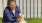a person kneeling down next to a dog